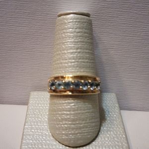 Series Of Sky Blue Topazes In A Gold Wash Ring